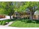 Charming, single-story home with mature trees and a well-manicured lawn at 10769 Carrol Ln, Northglenn, CO 80233