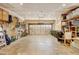 Spacious garage featuring exposed brick, storage shelving, and room for parking and projects at 10769 Carrol Ln, Northglenn, CO 80233