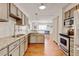 Well-lit kitchen with stainless appliances, granite countertops, and hardwood floors at 10769 Carrol Ln, Northglenn, CO 80233