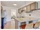 Charming kitchen with granite countertops, stainless steel appliances, and seating at the counter at 10769 Carrol Ln, Northglenn, CO 80233