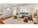 Inviting living room with hardwood floors, neutral decor, and lots of natural light at 10769 Carrol Ln, Northglenn, CO 80233