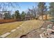 Spacious backyard with a manicured lawn, stepping stones, a gazebo with seating, and a wooden fence at 9805 Keenan St, Highlands Ranch, CO 80130
