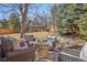 Inviting backyard patio featuring an outdoor seating area with a stone fire pit and a gazebo in a landscaped yard at 9805 Keenan St, Highlands Ranch, CO 80130