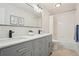 Bright bathroom featuring a double vanity with modern fixtures and a shower-tub combination at 9805 Keenan St, Highlands Ranch, CO 80130