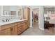 The bathroom boasts a double sink vanity, modern fixtures, and access to a walk-in closet, combining luxury and function at 9805 Keenan St, Highlands Ranch, CO 80130