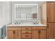 This bathroom features a double sink vanity, a well-lit mirror, and ample storage, providing convenience and style at 9805 Keenan St, Highlands Ranch, CO 80130