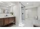 Modern bathroom with dark wood vanity, frameless glass shower and sleek black fixtures at 9805 Keenan St, Highlands Ranch, CO 80130