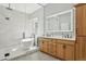 The modern bathroom includes a spacious glass shower, soaking tub, double sink vanity, and stylish fixtures at 9805 Keenan St, Highlands Ranch, CO 80130