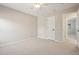 Cozy bedroom with neutral walls, ceiling fan, and plush carpeting, bathed in natural light at 9805 Keenan St, Highlands Ranch, CO 80130