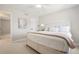 Bright bedroom is furnished with a bed and features a modern design scheme and an ensuite bathroom at 9805 Keenan St, Highlands Ranch, CO 80130