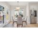 Bright dining area featuring stainless steel refrigerator, a modern pendant light, and ample natural light at 9805 Keenan St, Highlands Ranch, CO 80130