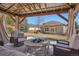 Relaxing view from the gazebo, showcasing outdoor seating, a fire pit, and a glimpse of the home and backyard at 9805 Keenan St, Highlands Ranch, CO 80130