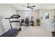 Bright room with a treadmill, desk, and natural light, ideal for a home office and fitness area at 9805 Keenan St, Highlands Ranch, CO 80130