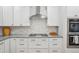 Close up of a well-equipped kitchen featuring stainless steel appliances and custom cabinetry at 9805 Keenan St, Highlands Ranch, CO 80130