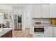 Bright, modern kitchen showcasing stainless steel refrigerator and built in microwave at 9805 Keenan St, Highlands Ranch, CO 80130