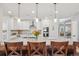 Bright, open kitchen features white cabinets, stainless appliances, granite countertops, and pendant lighting at 9805 Keenan St, Highlands Ranch, CO 80130