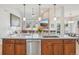 Open kitchen with large island offering bar seating and stainless steel appliances with seamless views to living room at 9805 Keenan St, Highlands Ranch, CO 80130