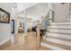Open living and dining area showcasing hardwood floors, natural light, and a staircase at 9805 Keenan St, Highlands Ranch, CO 80130