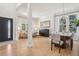 Bright, open living and dining areas with hardwood floors, large windows, and elegant light fixtures at 9805 Keenan St, Highlands Ranch, CO 80130