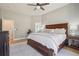 This main bedroom features a large bed, ceiling fan, and ensuite bathroom for a luxurious and comfortable living space at 9805 Keenan St, Highlands Ranch, CO 80130