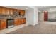 Basement area with kitchenette with wood cabinets, stone backsplash, and a barn door at 10272 Greenfield Cir, Parker, CO 80134