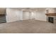Spacious finished basement with plush carpet, fireplace with stone surround, and staircase at 10272 Greenfield Cir, Parker, CO 80134
