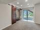 Finished basement featuring sliding barn doors and a sliding glass door to backyard at 10272 Greenfield Cir, Parker, CO 80134