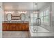 Primary bathroom showcasing a tub, walk-in shower, double sink vanity, and oval mirrors at 10272 Greenfield Cir, Parker, CO 80134