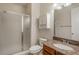 Bathroom featuring a shower with glass door, granite counters and a cabinet for storage at 10272 Greenfield Cir, Parker, CO 80134