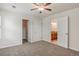 Spacious bedroom featuring neutral walls, ceiling fan, and access to bathroom and closet at 10272 Greenfield Cir, Parker, CO 80134