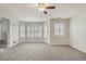 Large bright bedroom with carpet, bay windows with shutters and an ensuite bathroom at 10272 Greenfield Cir, Parker, CO 80134