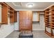 Spacious walk-in closet with carpet flooring, custom built-in shelves and drawers at 10272 Greenfield Cir, Parker, CO 80134