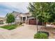 Home exterior featuring a well manicured lawn and a two car garage at 10272 Greenfield Cir, Parker, CO 80134