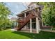 Rear exterior view of home with deck, outdoor patio, and well-manicured lawn at 10272 Greenfield Cir, Parker, CO 80134