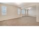 Open living room features recessed lights, neutral walls, carpet floors, and bright windows at 10272 Greenfield Cir, Parker, CO 80134