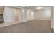 Open-concept living room area with neutral walls and carpet flooring, and decorative lighting at 10272 Greenfield Cir, Parker, CO 80134