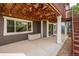Outdoor patio with covered deck above, supports, and backyard access at 10272 Greenfield Cir, Parker, CO 80134