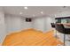 Spacious finished basement with hardwood flooring, neutral walls, and a small kitchenette at 5906 S Youngfield Way, Littleton, CO 80127