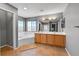 Bright bathroom features a double sink vanity, tiled floors, soaking tub, and large windows for natural light at 5906 S Youngfield Way, Littleton, CO 80127