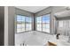 Lovely soaking tub in a bathroom with frosted windows to provide natural light and privacy at 5906 S Youngfield Way, Littleton, CO 80127