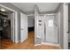 Contemporary bathroom with tiled floors, glass shower enclosure, and seamless transition to a large walk-in closet at 5906 S Youngfield Way, Littleton, CO 80127