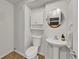 Bathroom features a white pedestal sink, toilet, and cabinet at 5906 S Youngfield Way, Littleton, CO 80127