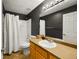 Cozy bathroom with hardwood-style flooring, white tiling, and a shower at 5906 S Youngfield Way, Littleton, CO 80127