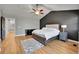 Large main bedroom with hardwood floors, vaulted ceilings, and stylish gray accent wall offers a peaceful retreat at 5906 S Youngfield Way, Littleton, CO 80127
