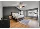Spacious main bedroom boasts vaulted ceilings, wood floors, large windows, and statement color accent wall at 5906 S Youngfield Way, Littleton, CO 80127