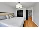 Bedroom with hardwood flooring, a bed with a padded headboard, and a wardrobe at 5906 S Youngfield Way, Littleton, CO 80127