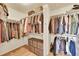Organized walk-in closet with hardwood floors features ample shelving and rods for optimal storage at 5906 S Youngfield Way, Littleton, CO 80127