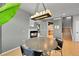 Dining area features hardwood floors, modern light fixture, and connects to an open floor plan at 5906 S Youngfield Way, Littleton, CO 80127