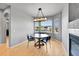 Bright dining area features hardwood floors, large windows, and modern lighting at 5906 S Youngfield Way, Littleton, CO 80127