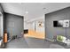 Home gym with rubber floor, TV, bar seating, and neutral decor at 5906 S Youngfield Way, Littleton, CO 80127